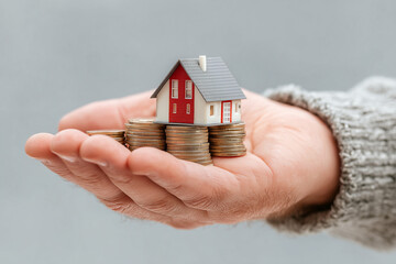 Hands Holding Gold Coins and Red House – Home Purchase Concept in Modern Collage Style on Transparent Background