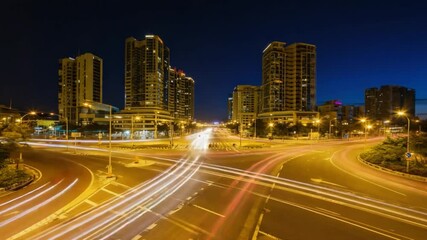 Roundabout traffic light trails during twilight transition