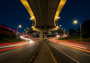 Fototapeta premium overpass with cars passing underneath on a lit night
