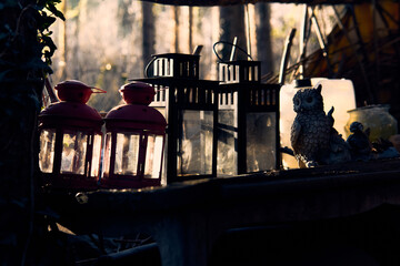 Charming lanterns and decorative owl in the serene alpine forest at dusk