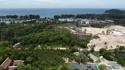 Bangtao area, investment expensive real estate on Phuket island. Construction of new luxury villas and condominiums and finished objects, drone view. Construction site, equipment and people working.