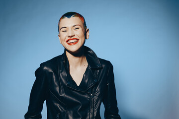 smiling woman with short hair wearing black leather jacket and bright red lipstick, joyful...