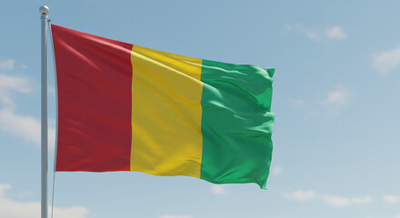 The national flag of Guinea waving gently in the morning breeze, isolated against a soft, cloudless sky.