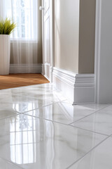 Bright and modern hallway with glossy marble tile flooring and natural light