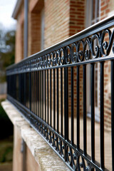 Decorative metal railing enhances balcony view in a sunny urban setting