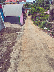 Narrow cement roads leading to boarding houses, bunkhouses or shelters that can only fit one car....