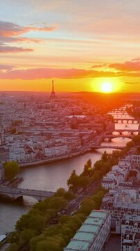The Eiffel Tower is beautifully illuminated at dusk, creating a stunning spectacle in Paris. vertical video