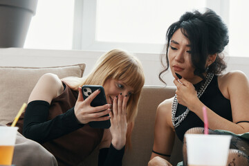 Young adult woman colleagues socializing and working together at the workplace, sharing ideas and...