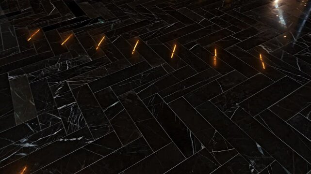 Polished black marble floor with herringbone pattern reflecting light