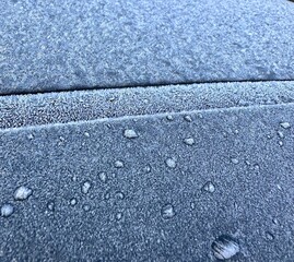 hoarfrost on a metal surface with delicate ice crystals shimmering