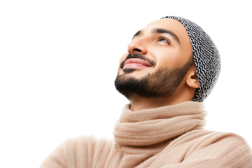 Young man in cozy sweater looking up with a hopeful smile against a black background, expressing optimism and tranquility in a peaceful moment of reflection