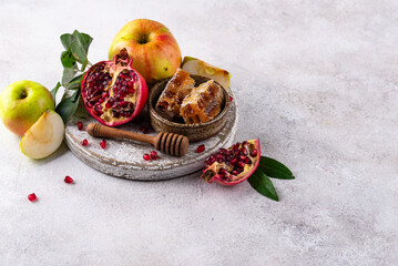 Rosh Hashana concept with honey, apple and pomegranate