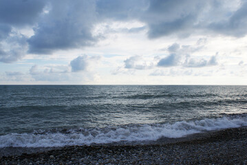 Sunset over sea, sun glare on water and clouds, background