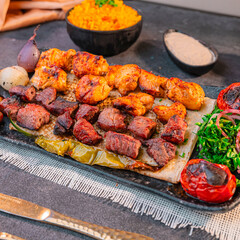 Grilled Chicken and Beef Skewers with Rice, Tahini Sauce, and fries