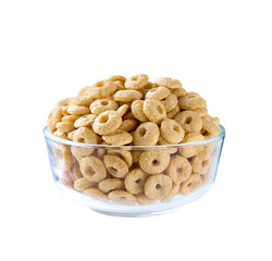 Whole grain cereal rings in a clear glass bowl isolated on a white background.