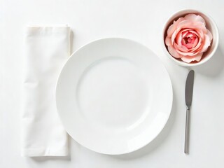 Elegant Dining Setup: Crisp White Plate, Silver Knife, Napkin, and Soft Pink Rose Bloom