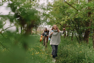 Fototapeta premium Middle age woman enjoying active outdoor walk with friends in lush green park, embracing wellness, health, and community lifestyle in spring season.