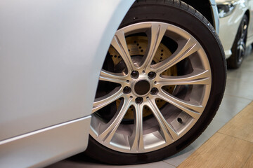 Detailed shot of a sleek black and silver alloy wheel on a motor vehicle
