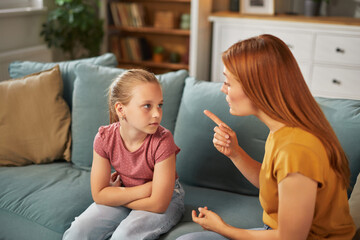 A mother engages in a serious conversation with her daughter, who appears to be listening intently...