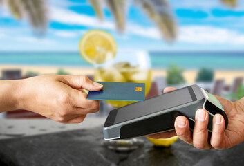 Side view of credit card contactless payment at tropical bar