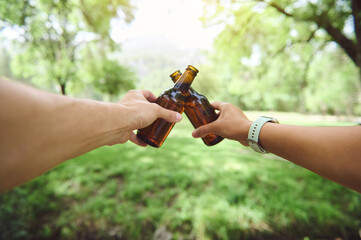 Cheers to a Refreshing Moment Outdoors with Friends in a Lush Green Park