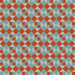 Pattern created from orange and pale teal green squares on a pale green background