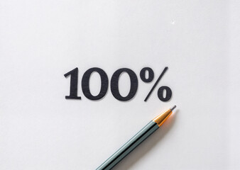 shows the number \"100%\" written in black on a white background, accompanied by a black pen with a gold-colored tip.