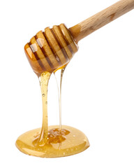 Honey dripping from wooden dipper isolated on transparent background