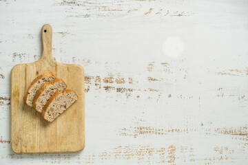 Two slices of toast on wooden cutting board.