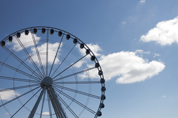 ferris wheel with clouds and blue sky