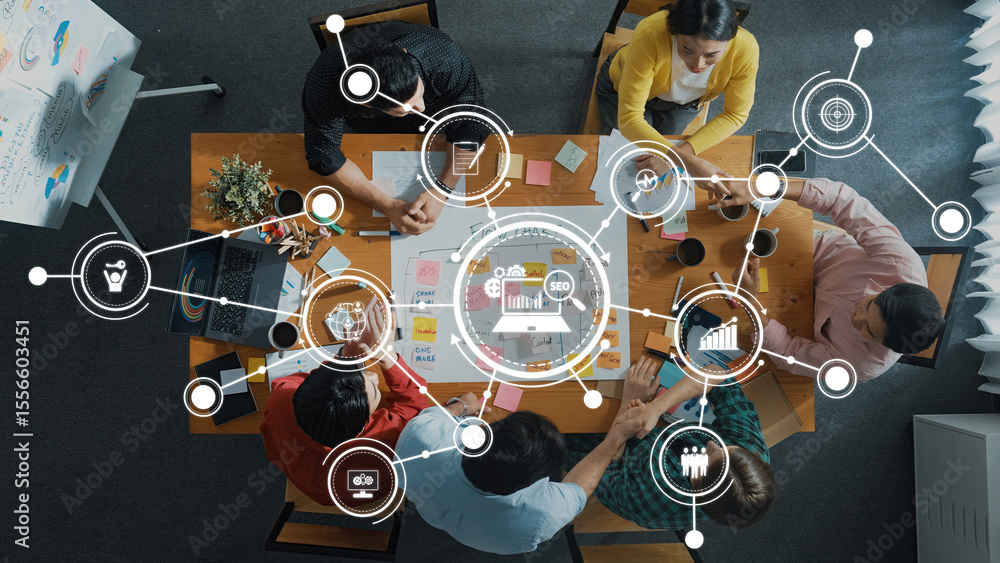 Poster a top-down view of a dynamic team meeting focused on data analysis and digital marketing. the worksp