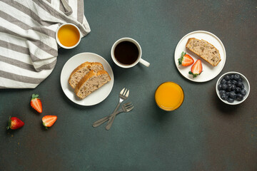 Nut cake, juice and coffee on striped napkin background.