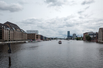 Fototapeta premium A wide view of the Spree River flowing through the Mediaspree district in Berlin, Germany.