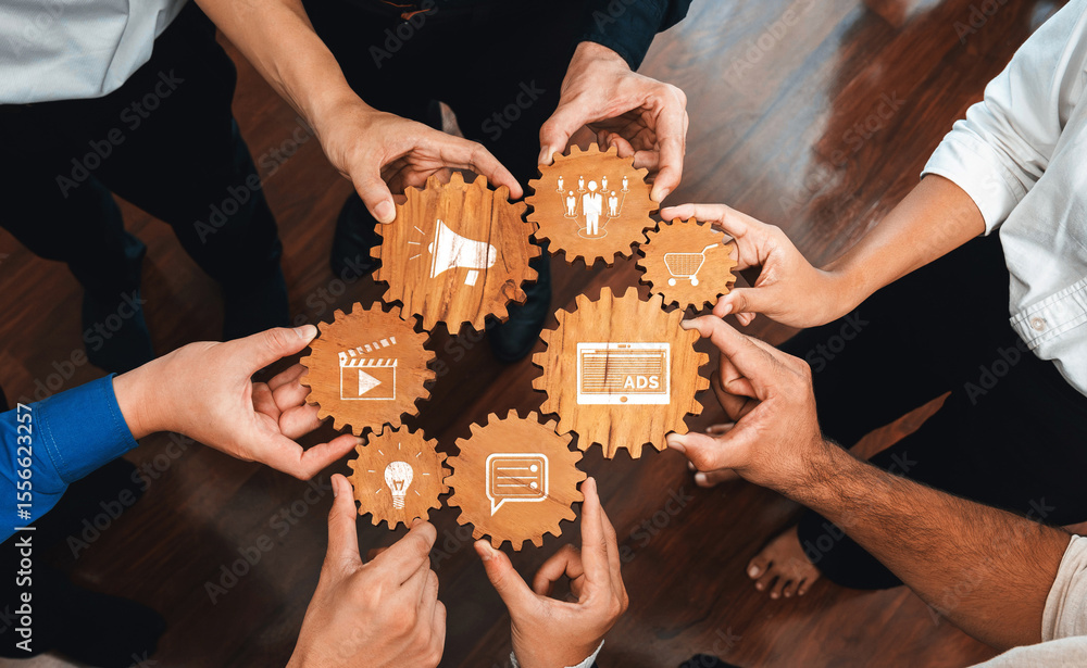 Poster A dynamic team collaborates with wooden cogs representing various aspects of advertising and creativity, symbolizing teamwork and innovation in a modern office environment. Amity