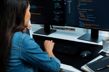 Young Asian in IT developer creating with typing online information on pc with coding program data...
