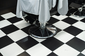 Elegant barbershop interior with classic black and white checkered floor