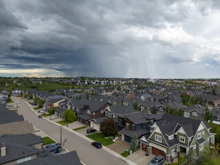 Thunderstorms rolling over suburban Calgary delivering rain and hail.