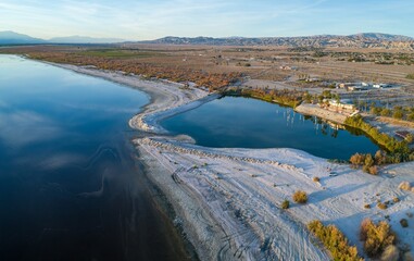 Aerial view of the Salton Sea, a shallow, saline lake in California, USA. The image captures the...
