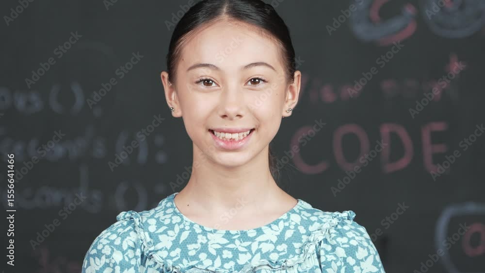 Poster cute caucasian girl looking at camera while standing at blackboard with engineering prompt. skilled 