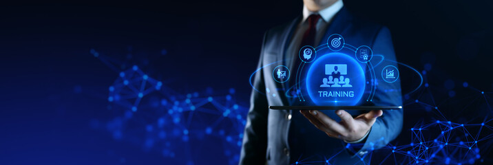 Obraz na płótnie Canvas Businessman Holding tablet with Training Icons on Screen. E-Learning and online Education concept