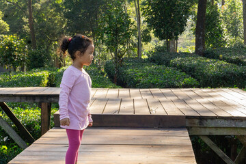 A daughter playing aline on green tea field garden