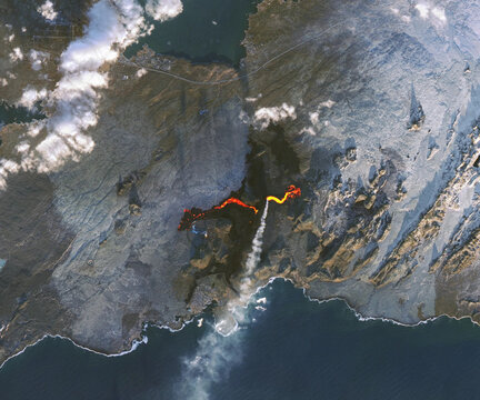 Aerial view of volcanic eruption with lava flow and steam plume in Iceland. Image courtesy of NASA.