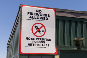 A sign prohibiting fireworks in a city in English and Spanish languages