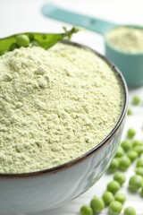 Protein powder in bowl and green peas on table, closeup