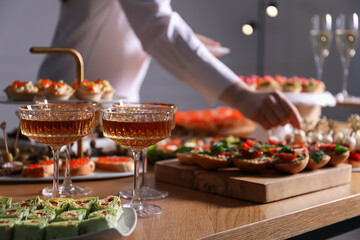 Buffet menu. Woman taking tasty canape from table, closeup