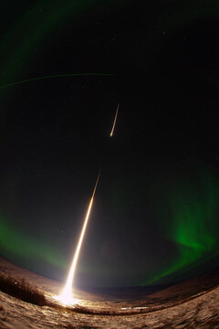 NASA sounding rocket launch with aurora borealis in the background. Poker Flat Research Range, Alaska. Image courtesy of NASA.