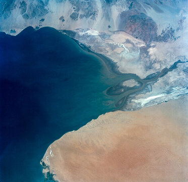 Aerial view of the Shatt al Arab River delta along the Persian Gulf, showing sediment patterns and coastal landforms. Image courtesy of NASA.