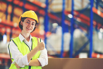 Female worker in warehouse, International import export , logistic business concept. Logistics, transportation, distribution concept. Team of factory workers working in logistic warehouse.

