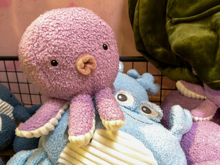 Cute Plush Purple Octopus Toy Surrounded by Soft Toys