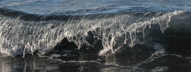 Crystal Clear Ocean Wave with White Foam Splash